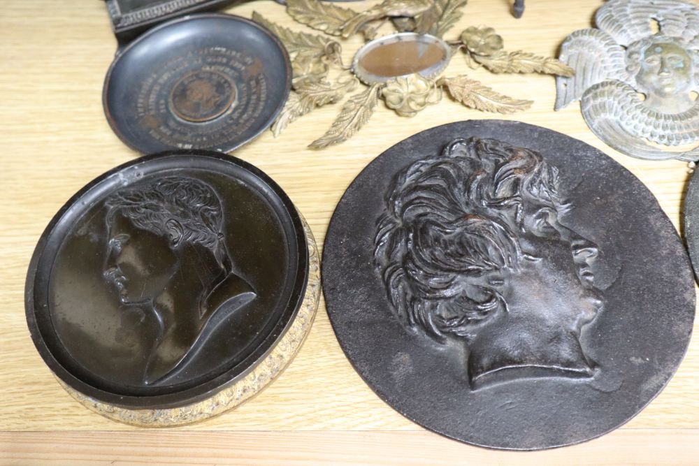 A group of 19th century iron and bronze ornaments, plaques, watch holder and urn